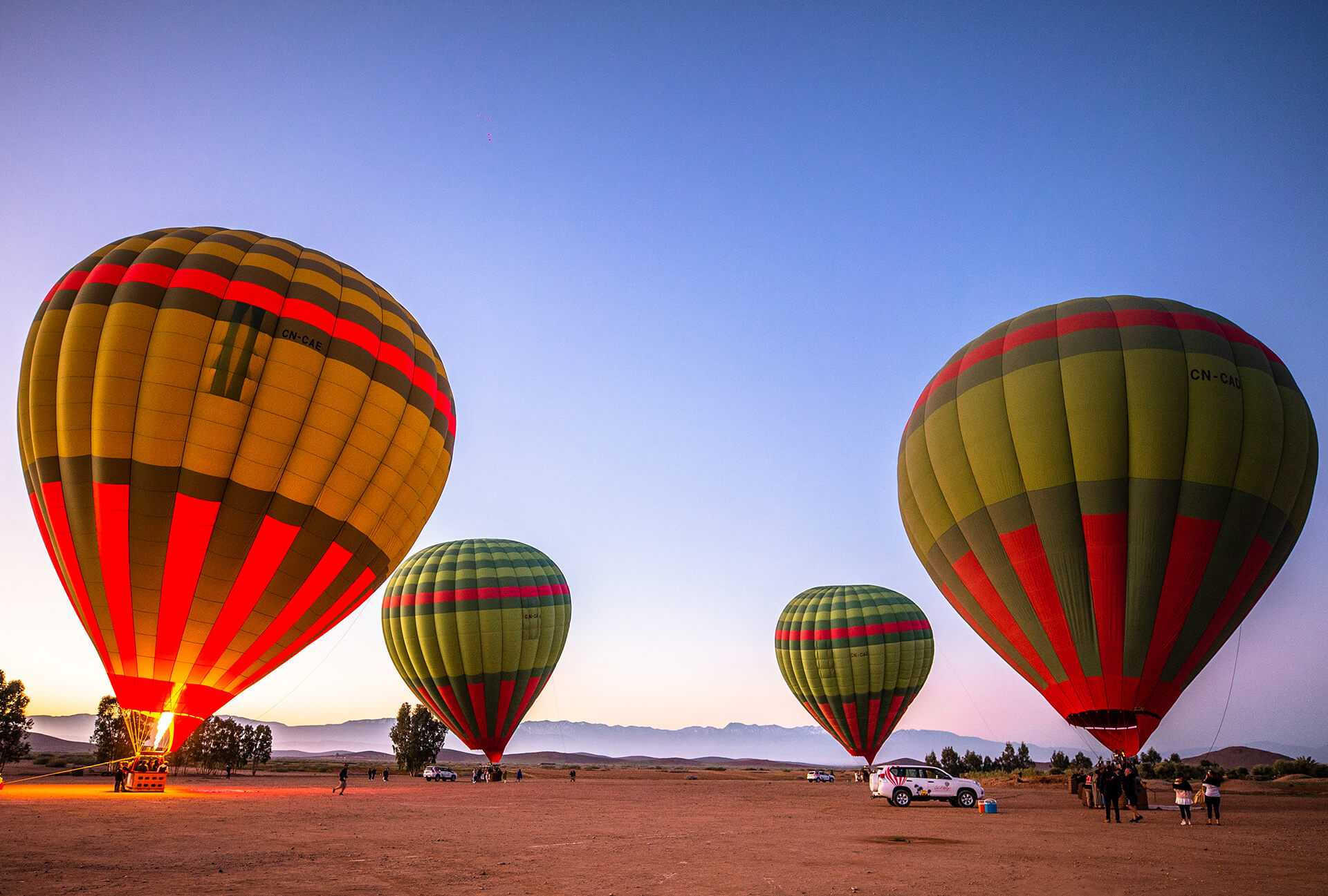 Hot air balloons flying over Marrakech and Atlas Mountains