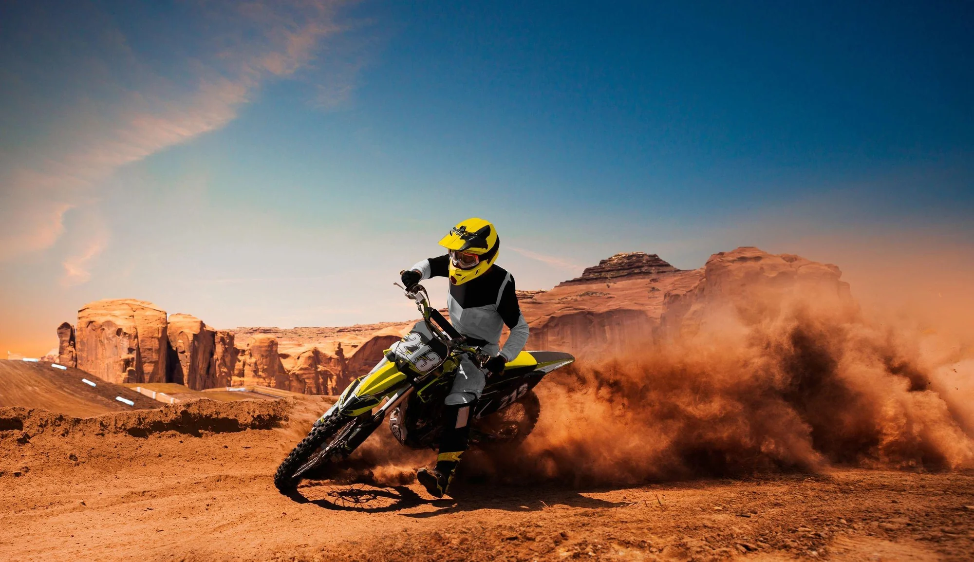 Motocross rider carving through desert terrain