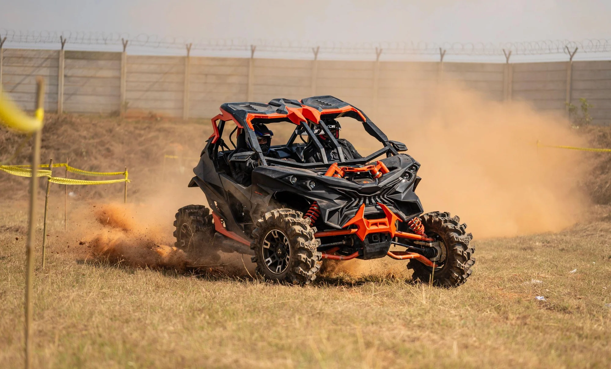 Orange off-road buggy cornering on a dirt track